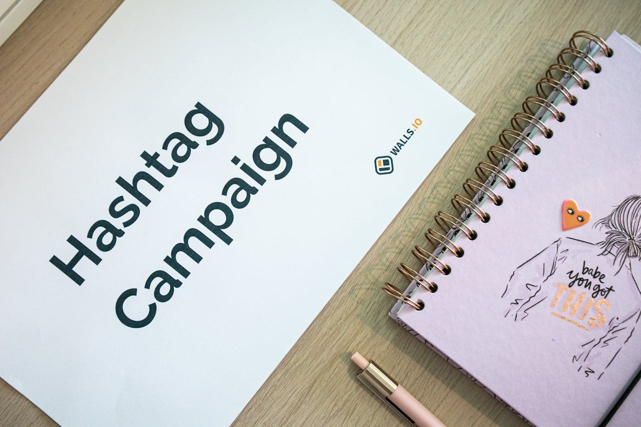 gallery-4 Creative desk setup featuring a hashtag campaign paper and a motivational notebook, ideal for marketing and planning themes.