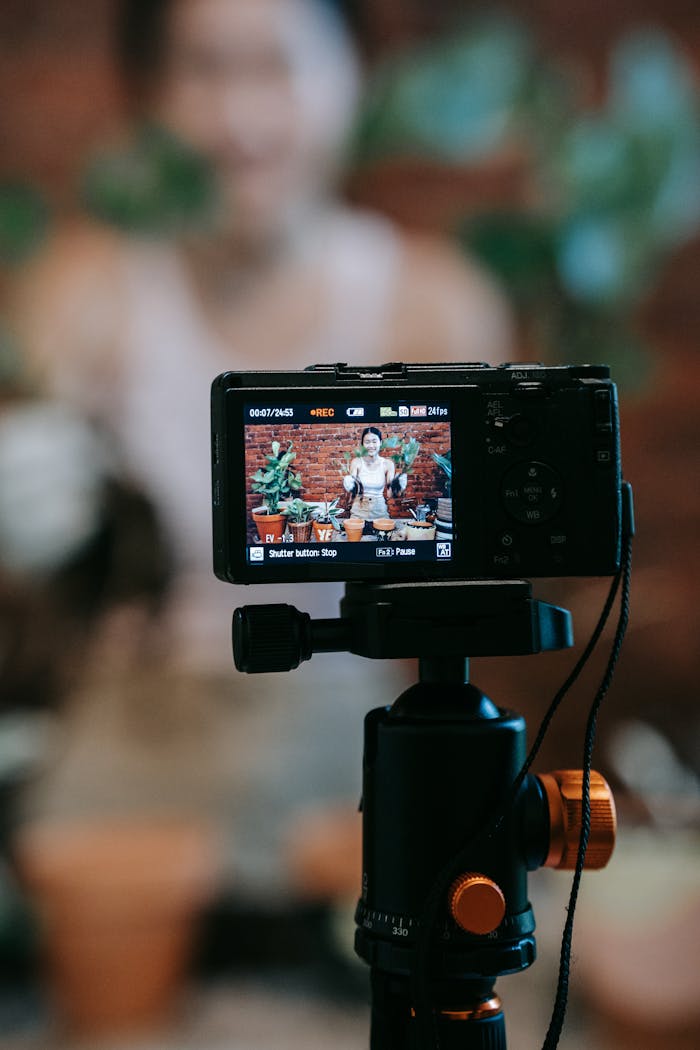 why-choose-us Vlogger recording a plant care tutorial with camera setup and potted plants.